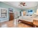 Inviting bedroom with tile floors, ceiling fan, and a light blue color scheme at 475 Holly Hill Rd, Oldsmar, FL 34677