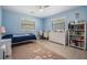 Comfortable bedroom with light blue walls, two windows, and white furniture at 475 Holly Hill Rd, Oldsmar, FL 34677
