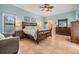 Spacious bedroom with tile flooring, wooden furniture, and a ceiling fan at 475 Holly Hill Rd, Oldsmar, FL 34677