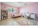 Cozy bedroom with pink walls, a large window and a reading nook at 475 Holly Hill Rd, Oldsmar, FL 34677