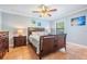 Charming bedroom with a wood bed frame, terracotta tile floors, and seaside-themed decor at 475 Holly Hill Rd, Oldsmar, FL 34677