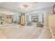 Bonus room with large mirror, two windows, and soft gray bean bag chairs at 475 Holly Hill Rd, Oldsmar, FL 34677
