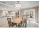 Dining room with chandelier and kitchen access, with outdoor access through french doors at 475 Holly Hill Rd, Oldsmar, FL 34677