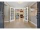 Open entryway with tile flooring, leading to living room with vaulted ceilings at 475 Holly Hill Rd, Oldsmar, FL 34677