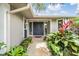 Close up of the front entrance with double doors, landscaping, and address at 475 Holly Hill Rd, Oldsmar, FL 34677