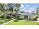 Charming house with manicured front yard and mature trees providing shade at 475 Holly Hill Rd, Oldsmar, FL 34677