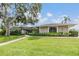 Well-maintained home exterior with walkway to front door and beautiful lawn at 475 Holly Hill Rd, Oldsmar, FL 34677