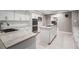 Stylish kitchen with white cabinetry, stainless steel appliances, and center island cooktop at 475 Holly Hill Rd, Oldsmar, FL 34677