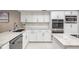 Bright kitchen featuring sleek stainless steel appliances, marble countertops and white subway tile backsplash at 475 Holly Hill Rd, Oldsmar, FL 34677