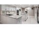 Modern kitchen with white cabinetry, stainless steel appliances, and an island cooktop at 475 Holly Hill Rd, Oldsmar, FL 34677
