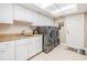 Well-organized laundry room featuring modern appliances and ample storage at 475 Holly Hill Rd, Oldsmar, FL 34677