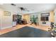 Versatile space with exercise equipment, desk area, and good lighting at 475 Holly Hill Rd, Oldsmar, FL 34677
