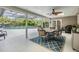 Inviting screened patio with dining area and views of the pool and lush landscaping at 475 Holly Hill Rd, Oldsmar, FL 34677