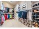 Spacious walk-in closet with custom shelves, cabinets, hanging racks, and tile flooring at 475 Holly Hill Rd, Oldsmar, FL 34677
