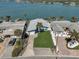 Waterfront home featuring manicured landscaping, a private dock, and stunning water views at 500 20Th Ave, Indian Rocks Beach, FL 33785