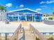 Waterfront backyard oasis with deck, pergola, hot tub, and seating, perfect for outdoor entertaining at 500 20Th Ave, Indian Rocks Beach, FL 33785