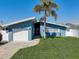Charming single-story home with vibrant blue siding, well-manicured lawn, and a one-car garage at 500 20Th Ave, Indian Rocks Beach, FL 33785