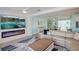 Bright living room with stylish decor, fireplace, and open-concept dining area at 500 20Th Ave, Indian Rocks Beach, FL 33785