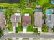 Birds-eye view reveals a neat neighborhood, including a manicured lawn, street access and adjacent pond views at 5016 Cypress Trace Dr, Tampa, FL 33624
