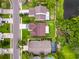 Aerial view showcases the property's location, bordering a pond, and its well-maintained lawn at 5016 Cypress Trace Dr, Tampa, FL 33624