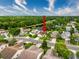 A tranquil aerial view of a single-Gathering home in a lush neighborhood near a pond, under a partly cloudy sky at 5016 Cypress Trace Dr, Tampa, FL 33624