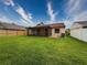 Spacious backyard boasts a well-maintained lawn and a covered patio perfect for entertaining at 5016 Cypress Trace Dr, Tampa, FL 33624