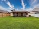 Expansive backyard featuring lush green lawn and a screened patio area for outdoor relaxation at 5016 Cypress Trace Dr, Tampa, FL 33624