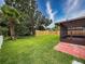 Spacious backyard with green grass, fenced perimeter and a screened-in patio at 5016 Cypress Trace Dr, Tampa, FL 33624