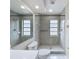 Walk-in shower with tiled walls, dual showerheads, and windows allowing natural light at 5016 Cypress Trace Dr, Tampa, FL 33624