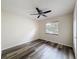 Bright bedroom featuring wood-look floors, a ceiling fan, and a window for natural light at 5016 Cypress Trace Dr, Tampa, FL 33624