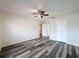 Bright bedroom features modern ceiling fan, fresh paint, and attractive gray wood-look floors at 5016 Cypress Trace Dr, Tampa, FL 33624