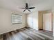 Neat bedroom with modern flooring, ceiling fan, and a window for natural light plus two doors at 5016 Cypress Trace Dr, Tampa, FL 33624