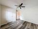 Well-lit bedroom offering hard floors, a ceiling fan, closet and entry door at 5016 Cypress Trace Dr, Tampa, FL 33624