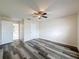 Comfortable bedroom with wood-look floors, ceiling fan, and an attached bath at 5016 Cypress Trace Dr, Tampa, FL 33624