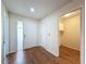 Warm and inviting foyer with hardwood floors, leading to various rooms and a glimpse of the laundry area at 5016 Cypress Trace Dr, Tampa, FL 33624