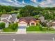 Charming single-story home featuring a two-car garage and well-maintained landscaping near a pond at 5016 Cypress Trace Dr, Tampa, FL 33624