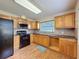 Functional kitchen featuring wood cabinets, sleek appliances, and efficient layout at 5016 Cypress Trace Dr, Tampa, FL 33624