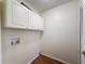 Practical laundry room with overhead cabinets and hookups at 5016 Cypress Trace Dr, Tampa, FL 33624