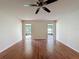 Bright living room showcasing gleaming hardwood floors and sliding glass doors leading to a screened patio at 5016 Cypress Trace Dr, Tampa, FL 33624