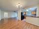 Open-concept living area with hardwood floors connecting to kitchen at 5016 Cypress Trace Dr, Tampa, FL 33624