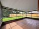 Enclosed patio offering tile floors and great views of the fenced backyard at 5016 Cypress Trace Dr, Tampa, FL 33624