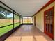 Enclosed porch featuring tile flooring and views of the fenced yard at 5016 Cypress Trace Dr, Tampa, FL 33624