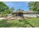 Backyard featuring a lush lawn and screened in patio at 5053 18Th St, Zephyrhills, FL 33542