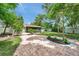 Backyard with brick patio, lawn, and shade trees at 5053 18Th St, Zephyrhills, FL 33542