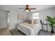 A simple bedroom with a ceiling fan and access to a small table at 5053 18Th St, Zephyrhills, FL 33542