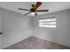 Neutral bedroom with a ceiling fan, tile floors, and one window at 5053 18Th St, Zephyrhills, FL 33542