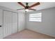 Neutral bedroom with a ceiling fan, carpet, closet, and one window at 5053 18Th St, Zephyrhills, FL 33542