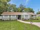 A single-story home with a brick walkway, green lawn, and neat landscaping at 5053 18Th St, Zephyrhills, FL 33542