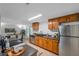 Well-lit kitchen featuring stainless steel appliances and wood cabinets for ample storage at 5053 18Th St, Zephyrhills, FL 33542