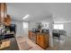 The kitchen offers wood cabinets, tile flooring, and a view into the living room at 5053 18Th St, Zephyrhills, FL 33542